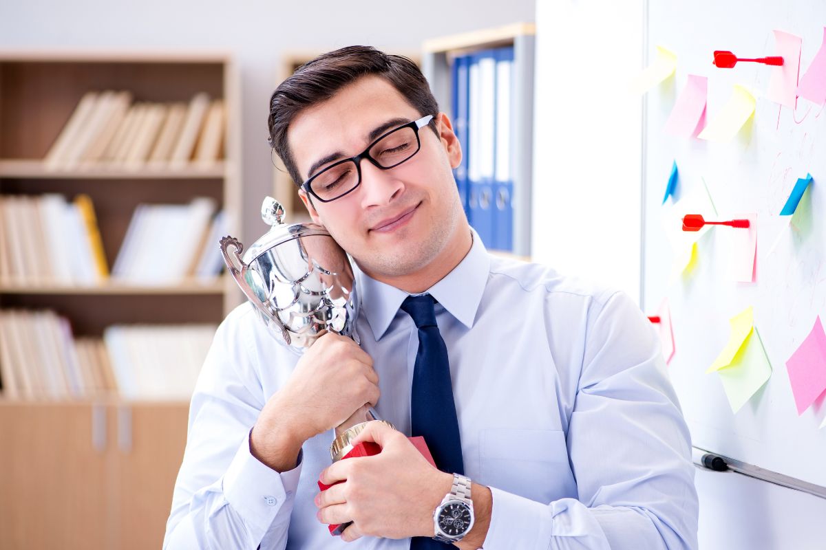 An office employee getting satisfied after getting prize for his hard work