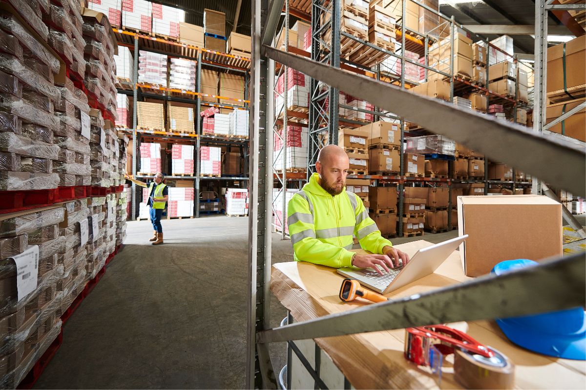 Man sitting inside a warehouse for dropshipping supplies