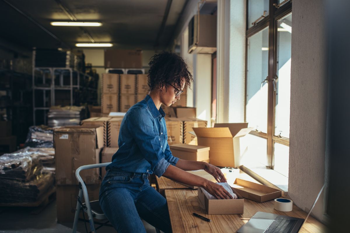 Woman packing products for dropshipping supplies