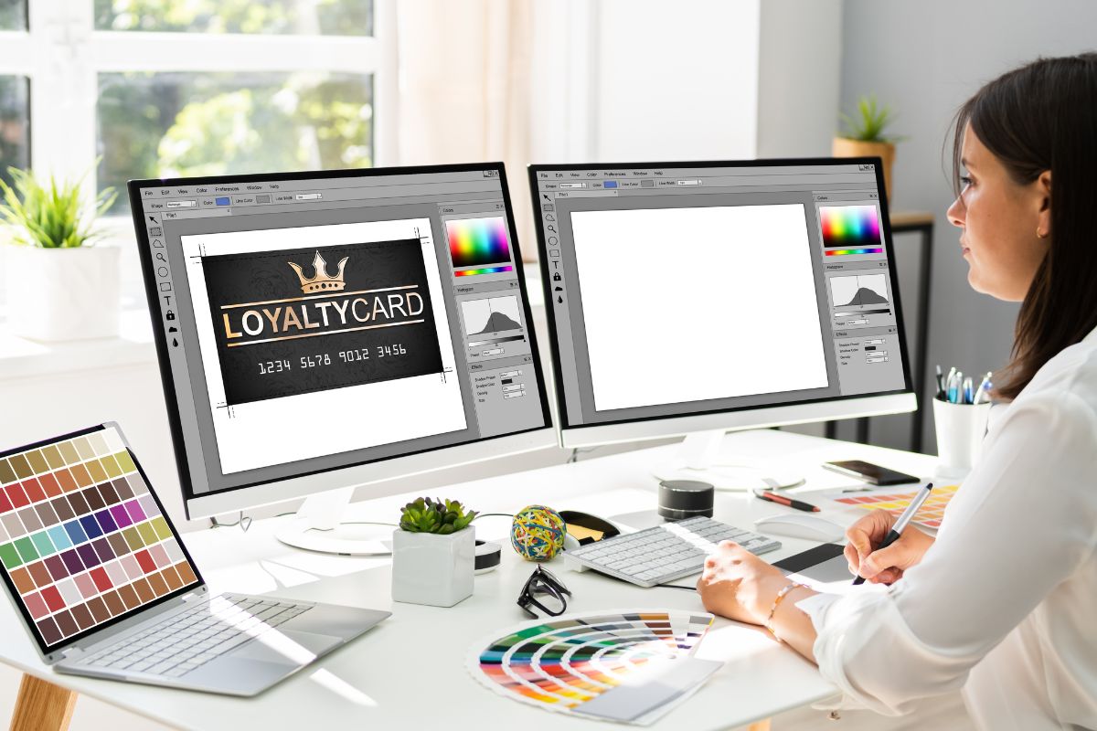 Woman working on desktops to design a logo by using a vector file
