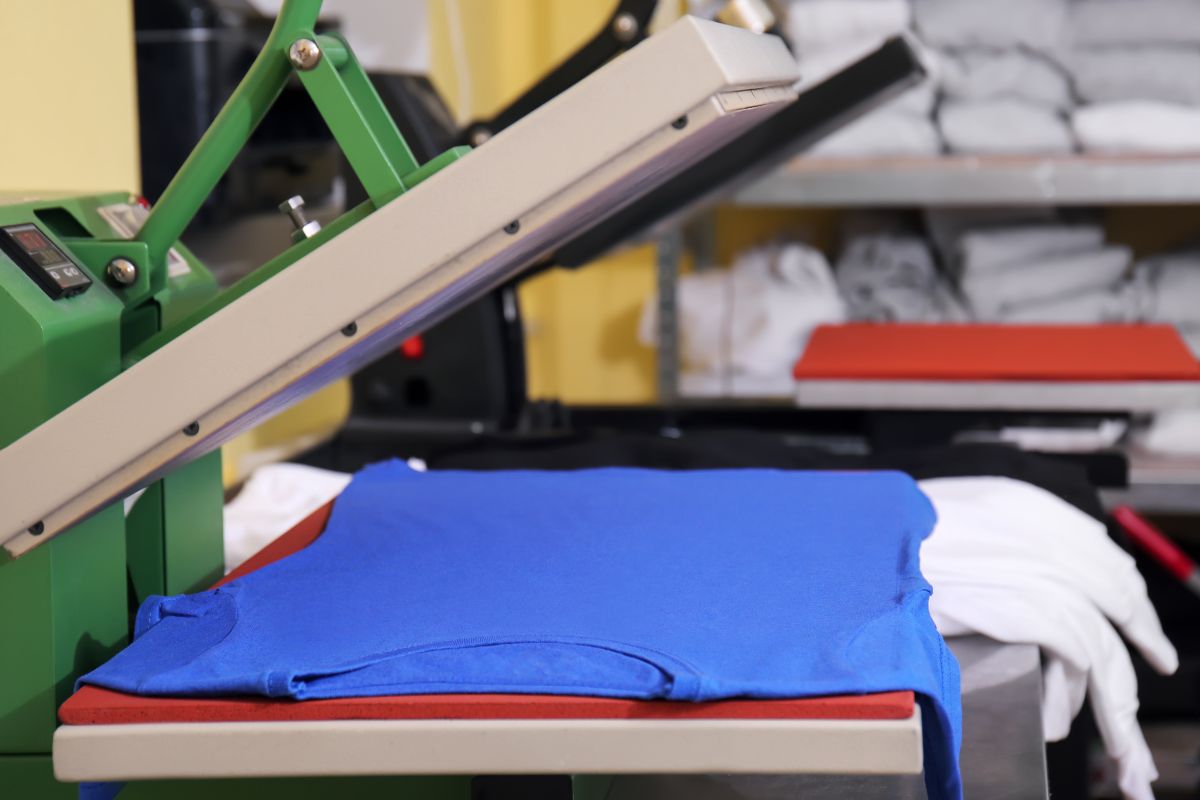 A T shirt being printed under screen printing machine