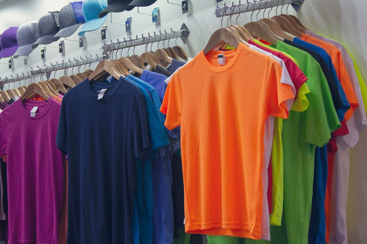 A huge collection of different colored t shirt kept together