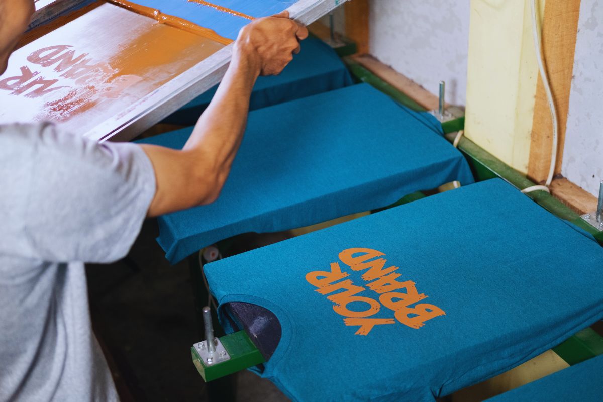 A man is printing crew neck blue t shirt