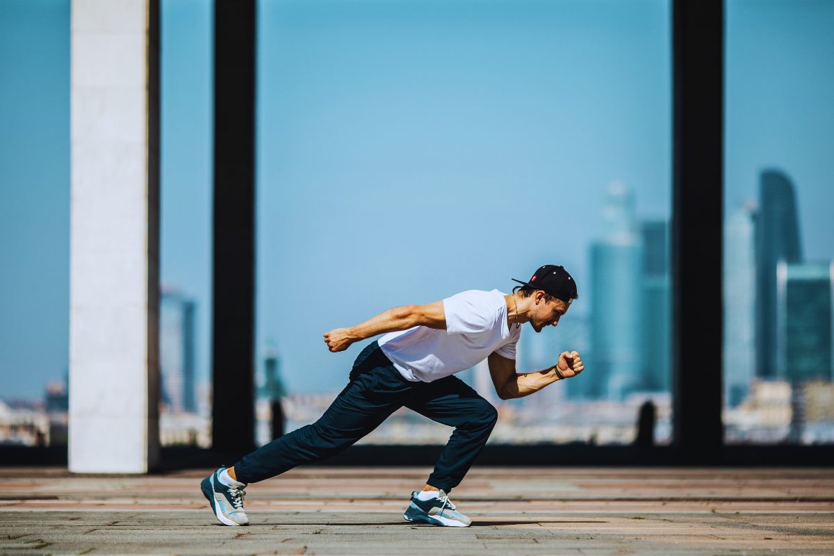 A man wearing white colour boxy fit t shirt and running