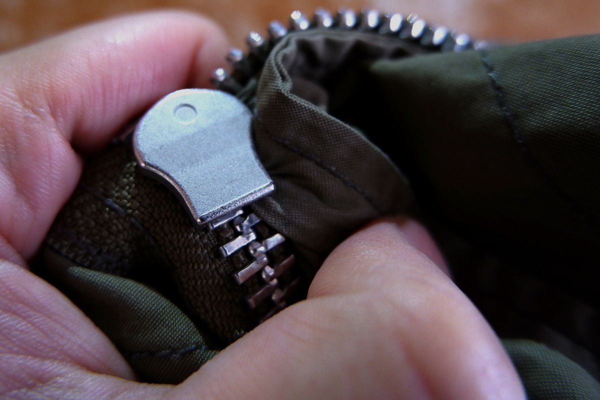 A person assessing the problem with the zipper funtionality