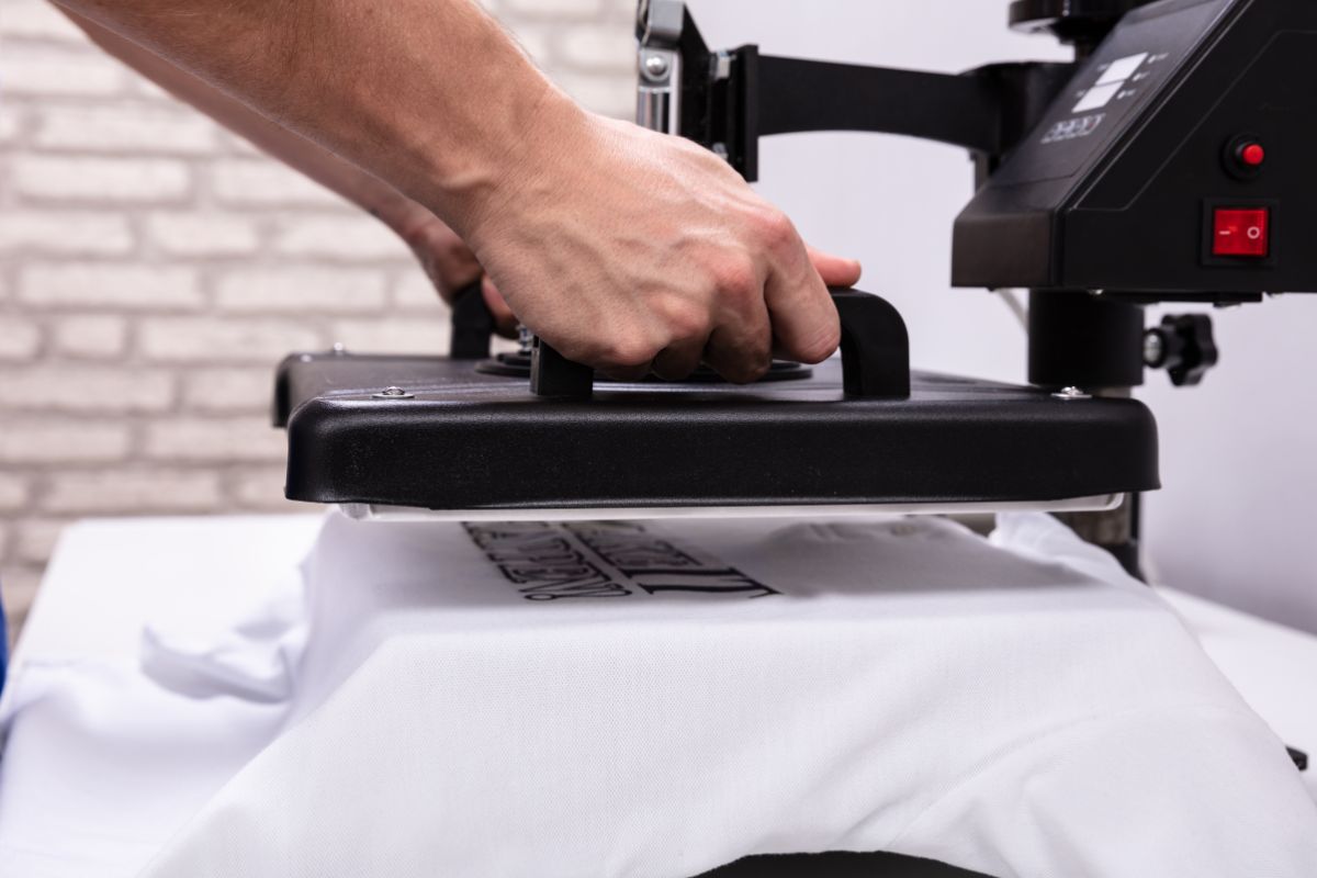 A person using heat printing option for shirt printing