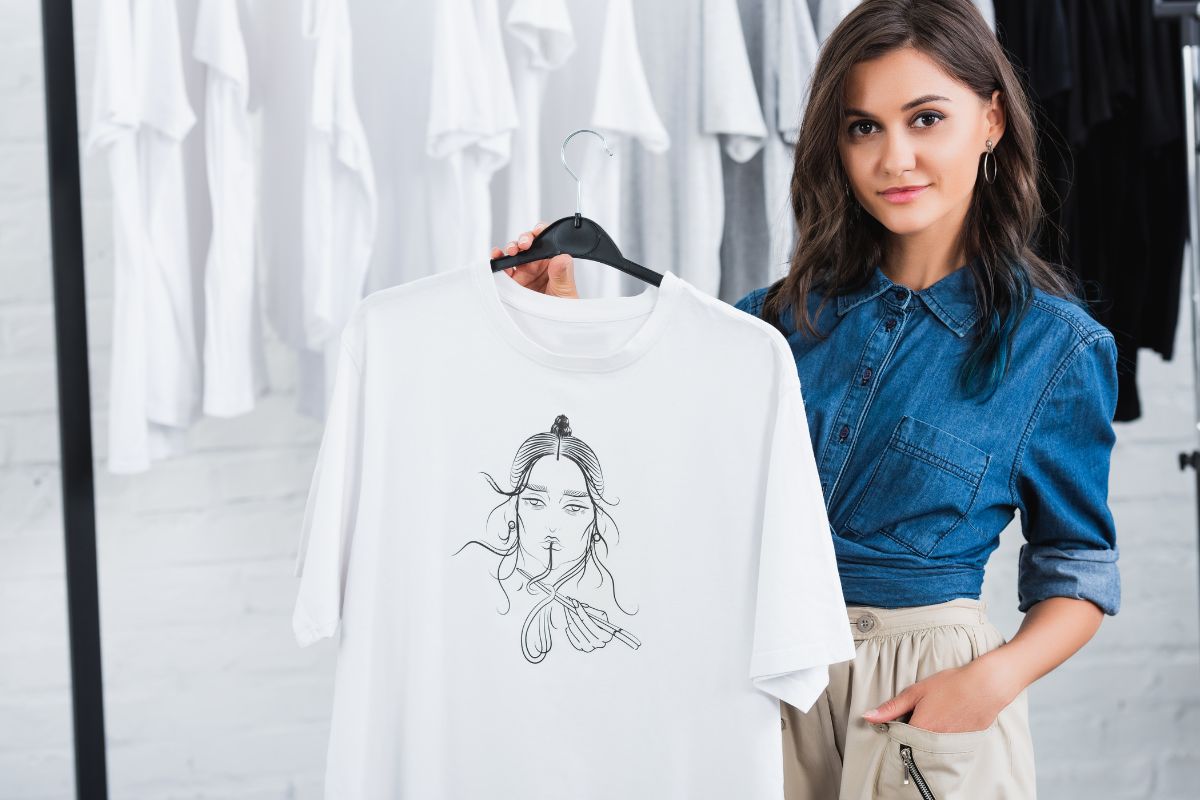 A woman hangs up a printed T shirt keeping its design intact