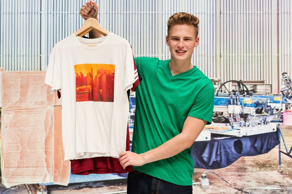 Man holding newly manufactured soft style t shirts