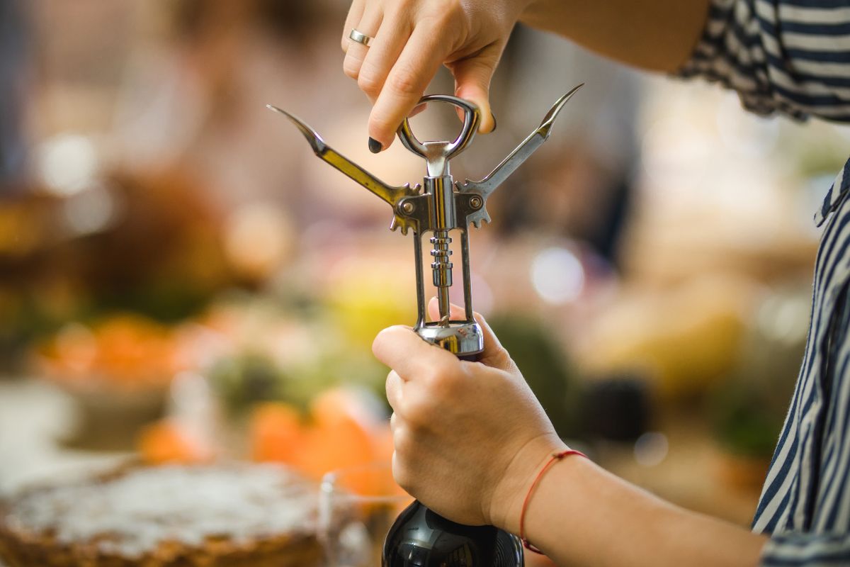 A man using a Wine Opener