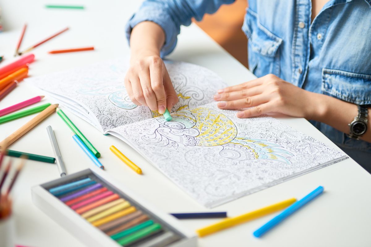 A nurse drawing on an adult coloring book to get relax