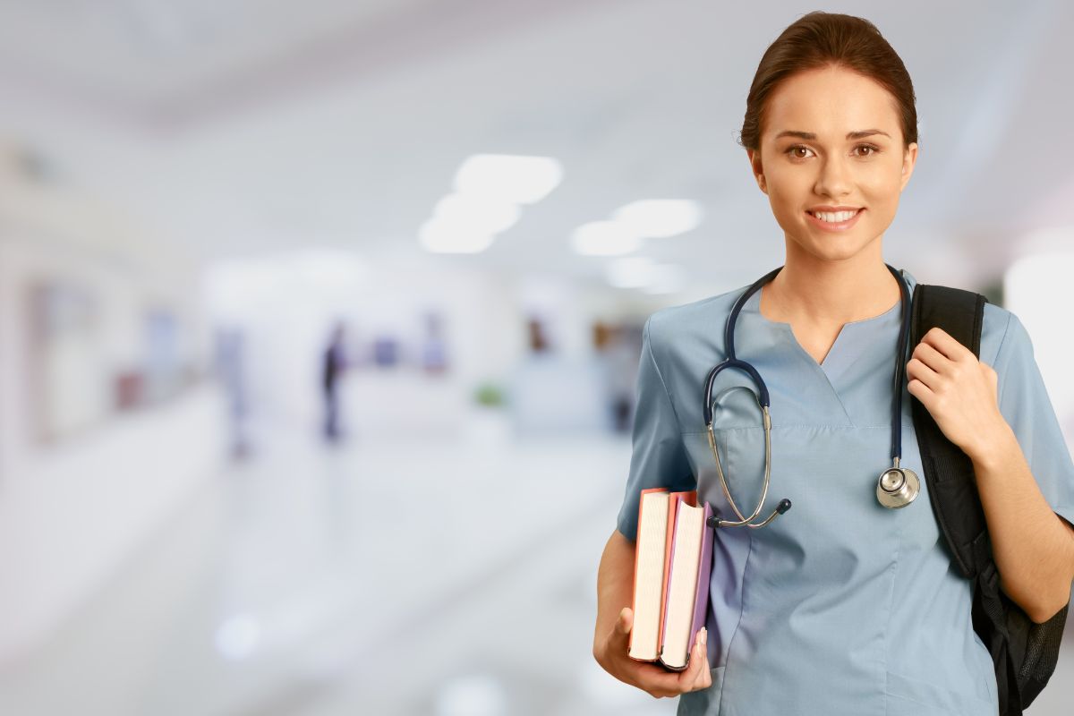 A nurse holding gifted self care books in her hand