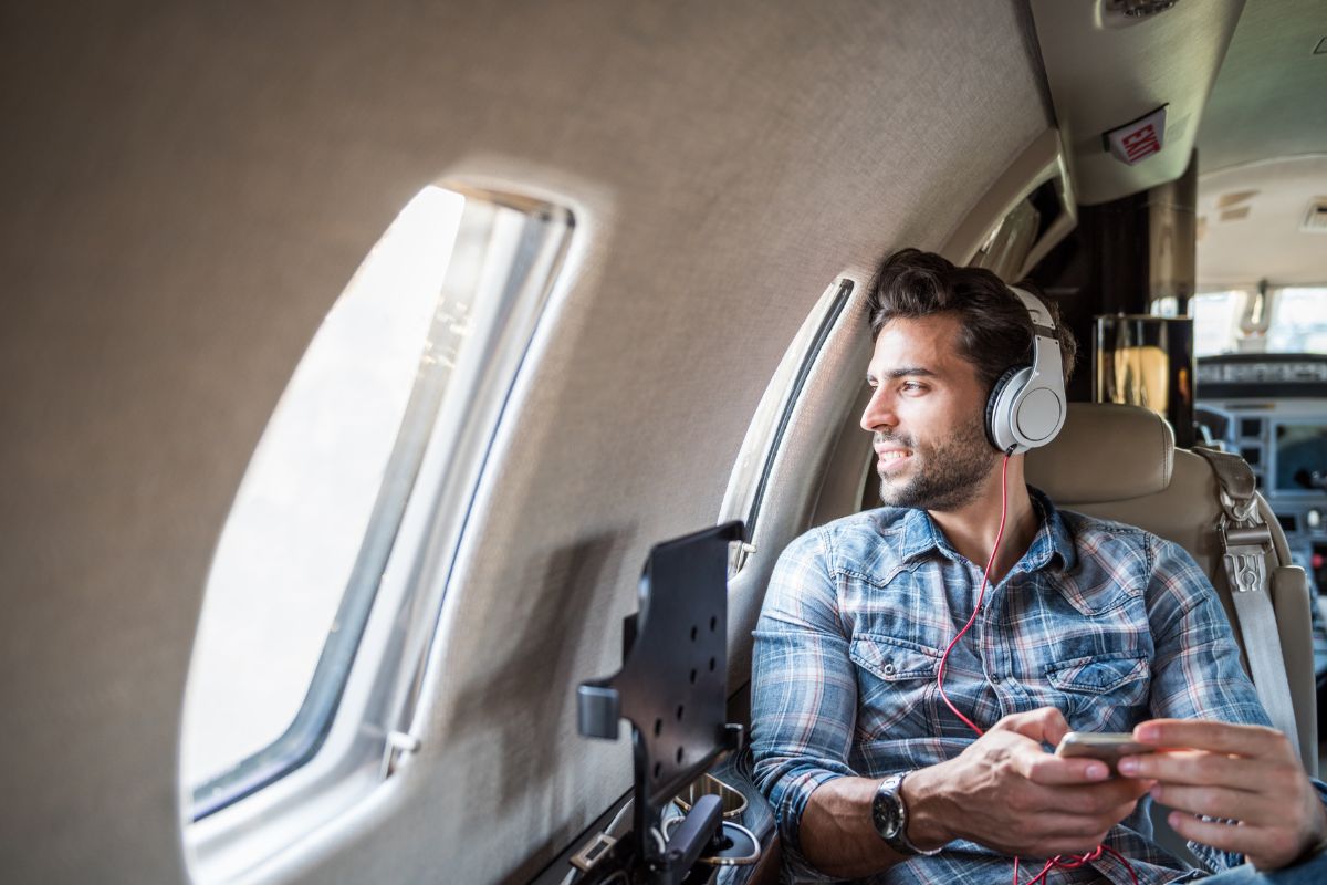 A traveller listening to songs with headphones