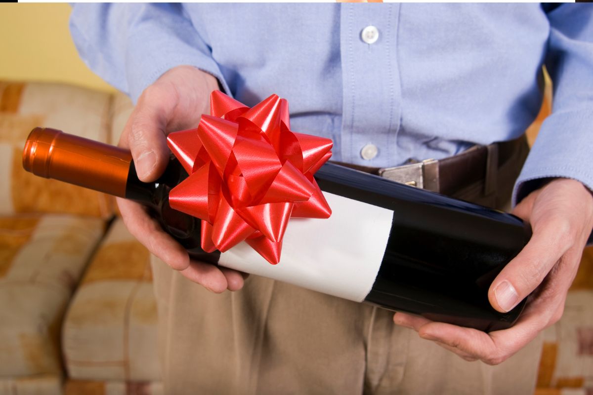 A wine bottle gift for the client carried by the business owner
