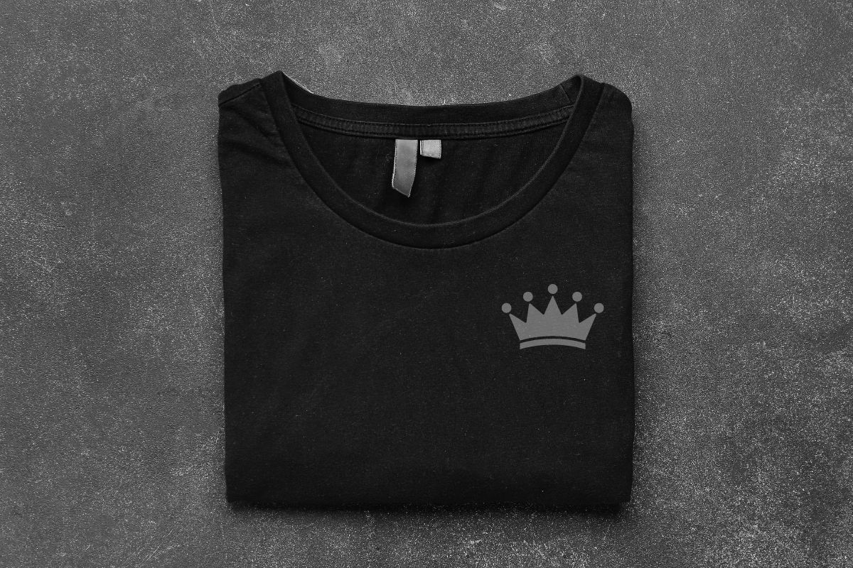 Black T Shirt with a logo on the left side