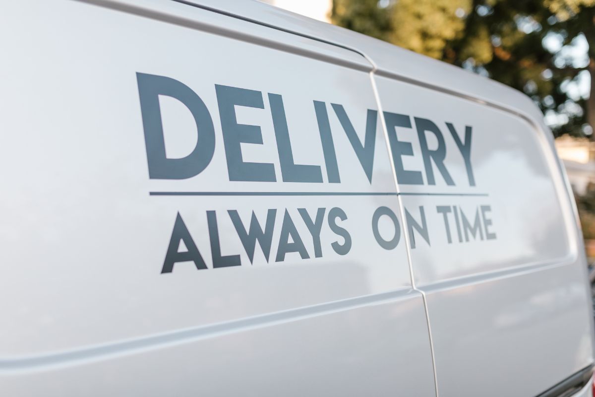 Delivery always on time written on a delivery van