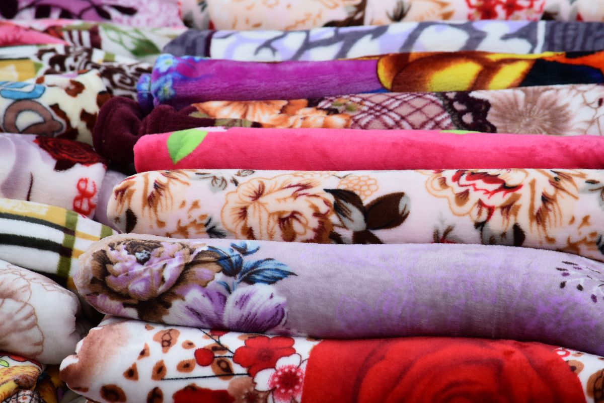 Different colored and printed blankets shown in the image