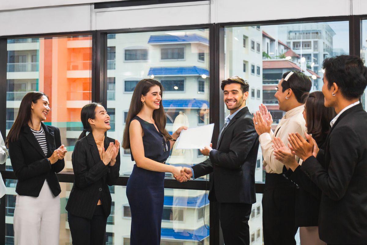 Employee celebrating 25 year work anniversary with each other.