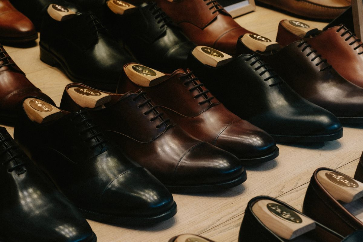 A collection of leather shoes kept together for sale.