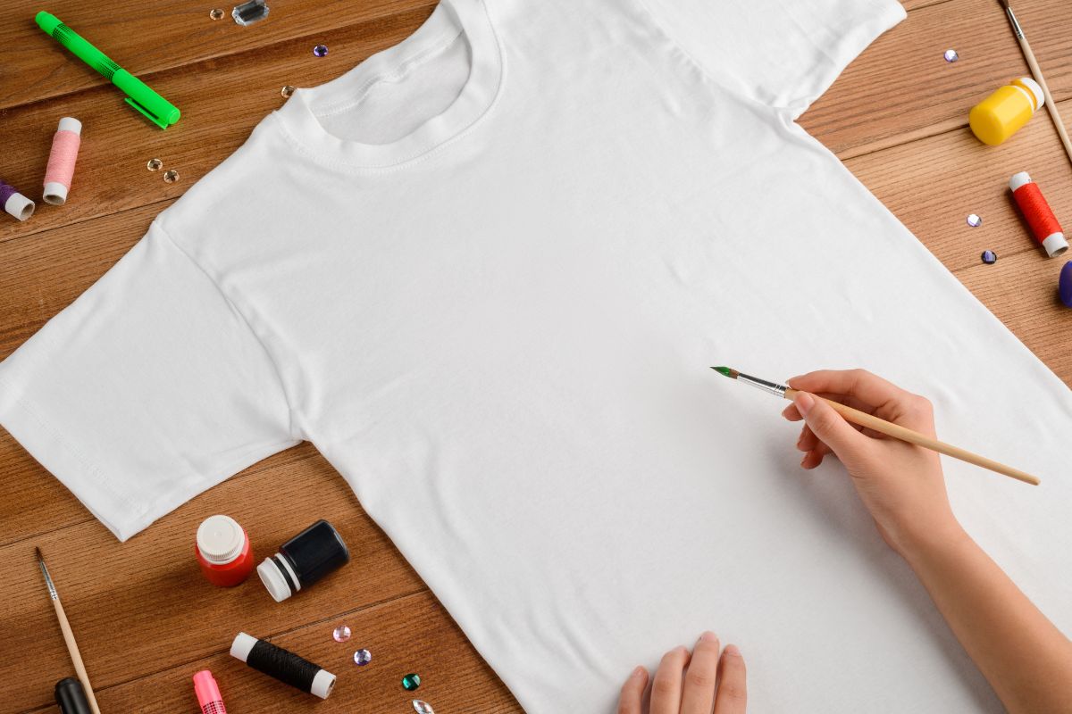 A lady designing custom artwork on the t shirt.