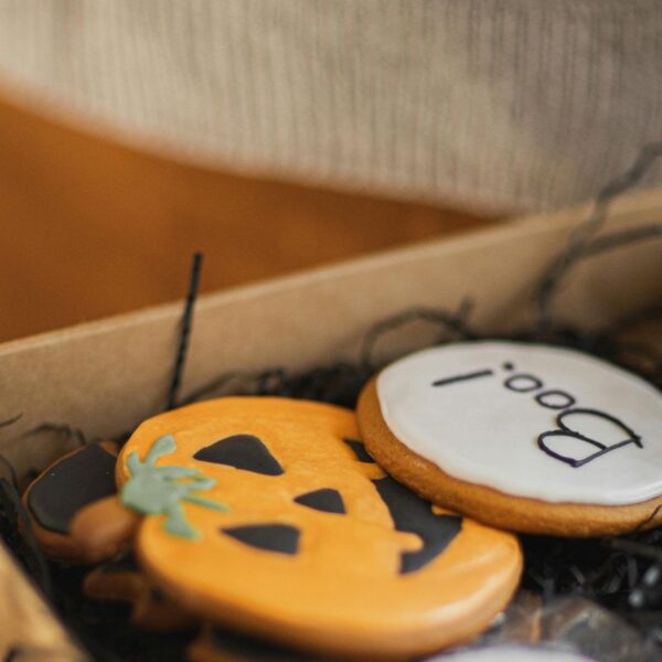 A lady packing halloween gifts.