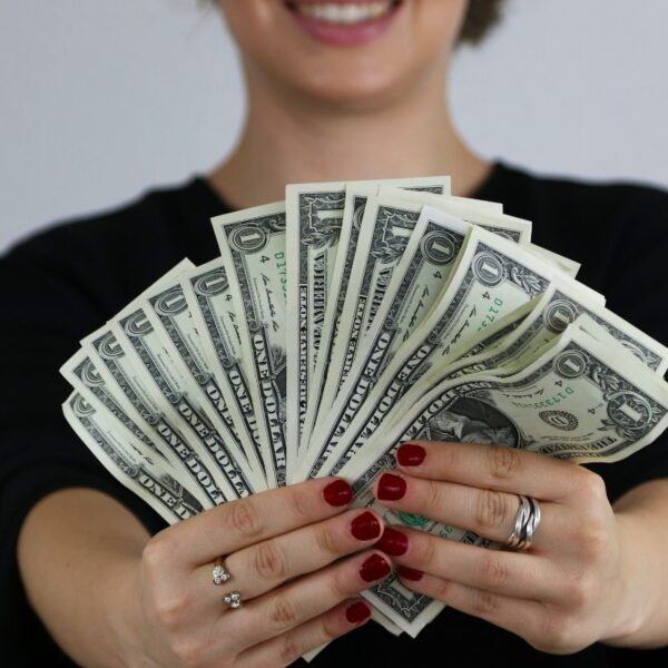 A lady showcasing money that she earned online.