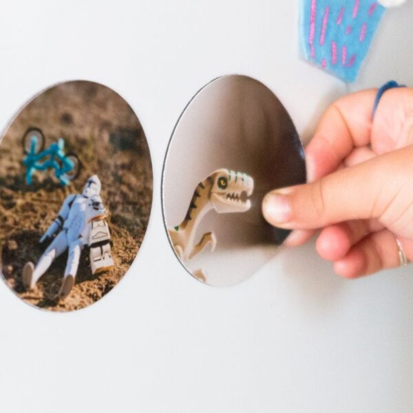 A lady showing custom magnets sticked to the metal frame.