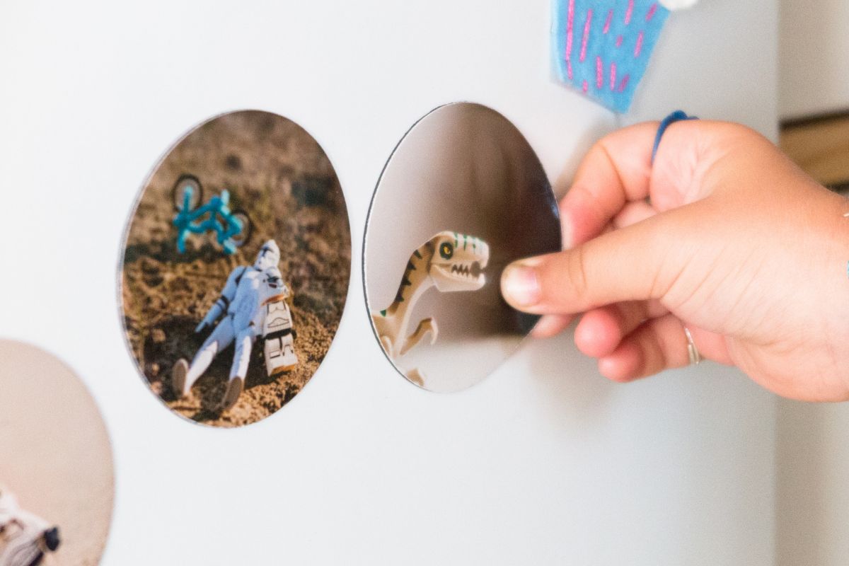 A lady showing custom magnets sticked to the metal frame.