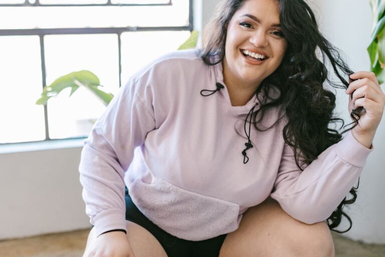 A lady wearing champion hoody made from cotton.