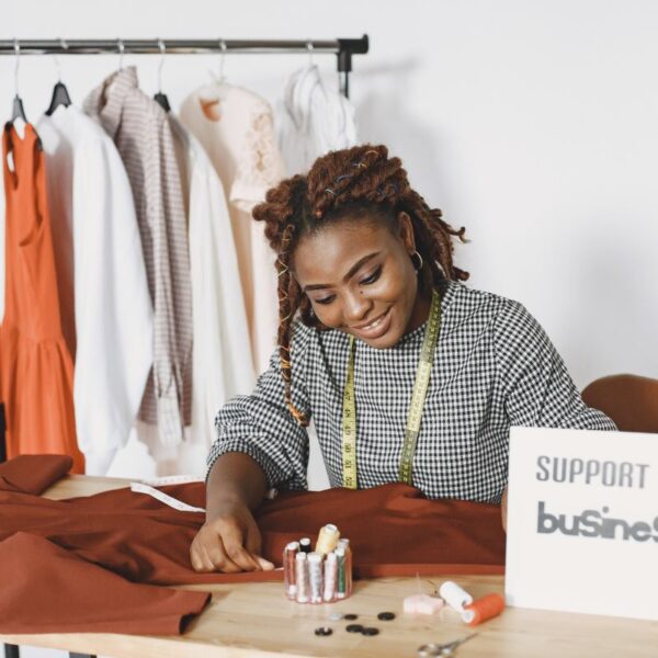 A lady working on her clothing design from home.