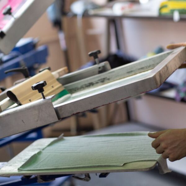 A person printing design on t shirt for his print on demand business.