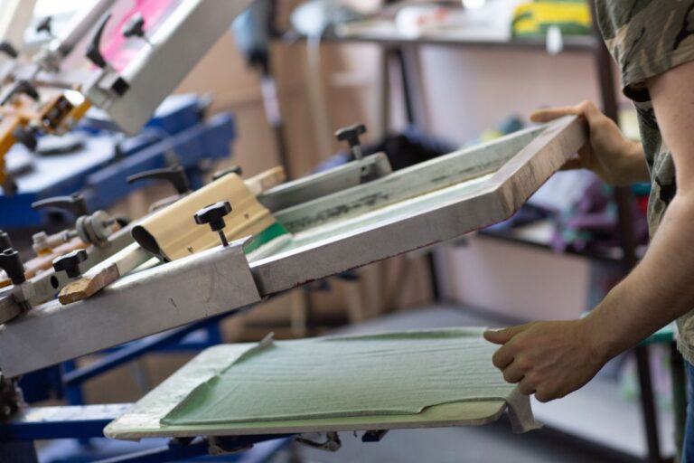 A person printing design on t shirt for his print on demand business.