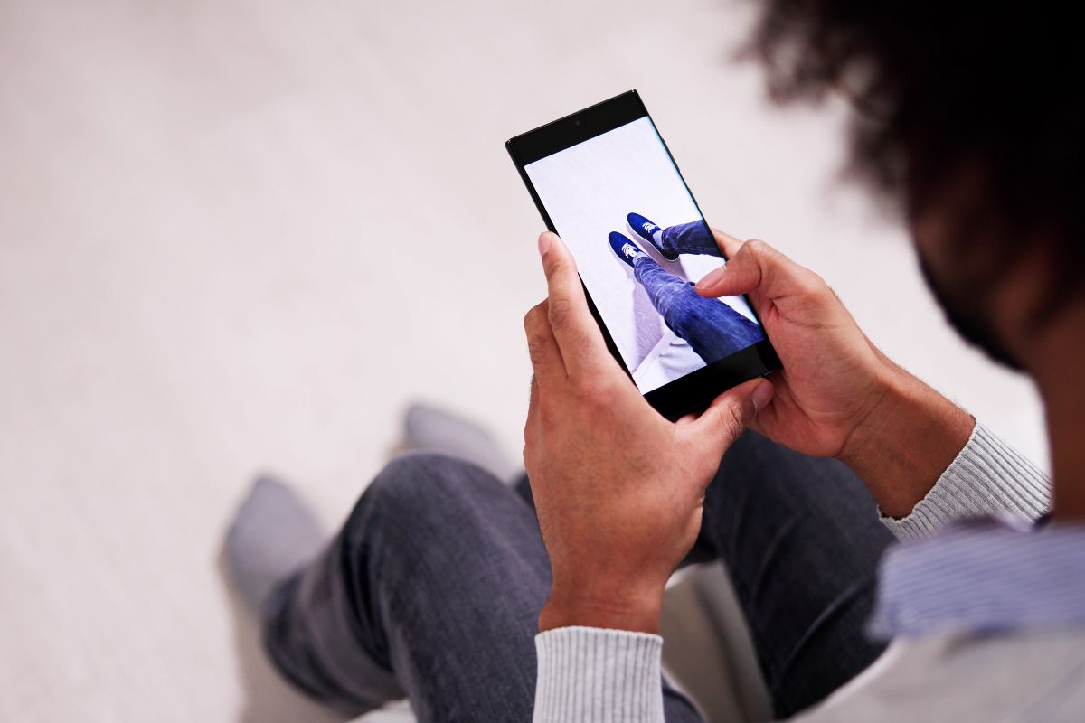 A person trying new shoes with the help of augmented reality