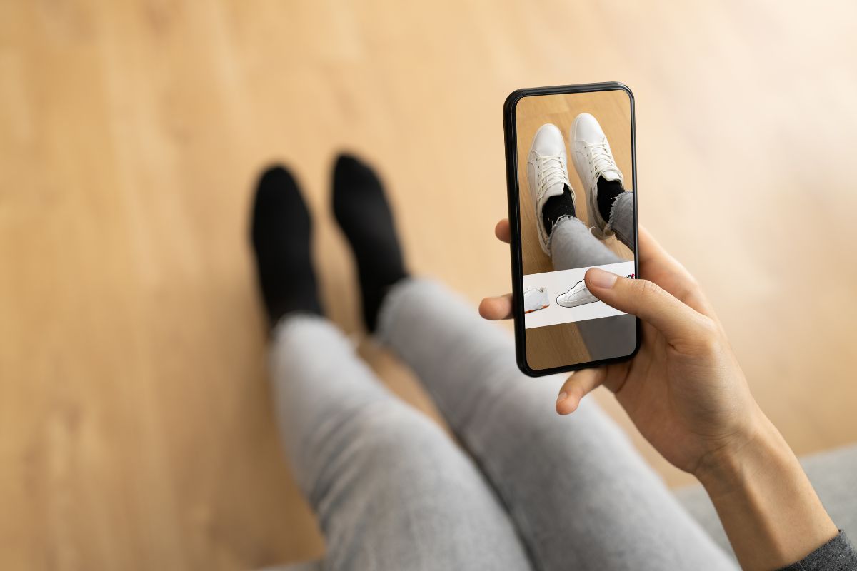 A woman using augmented reality to try on shoes without going to a store