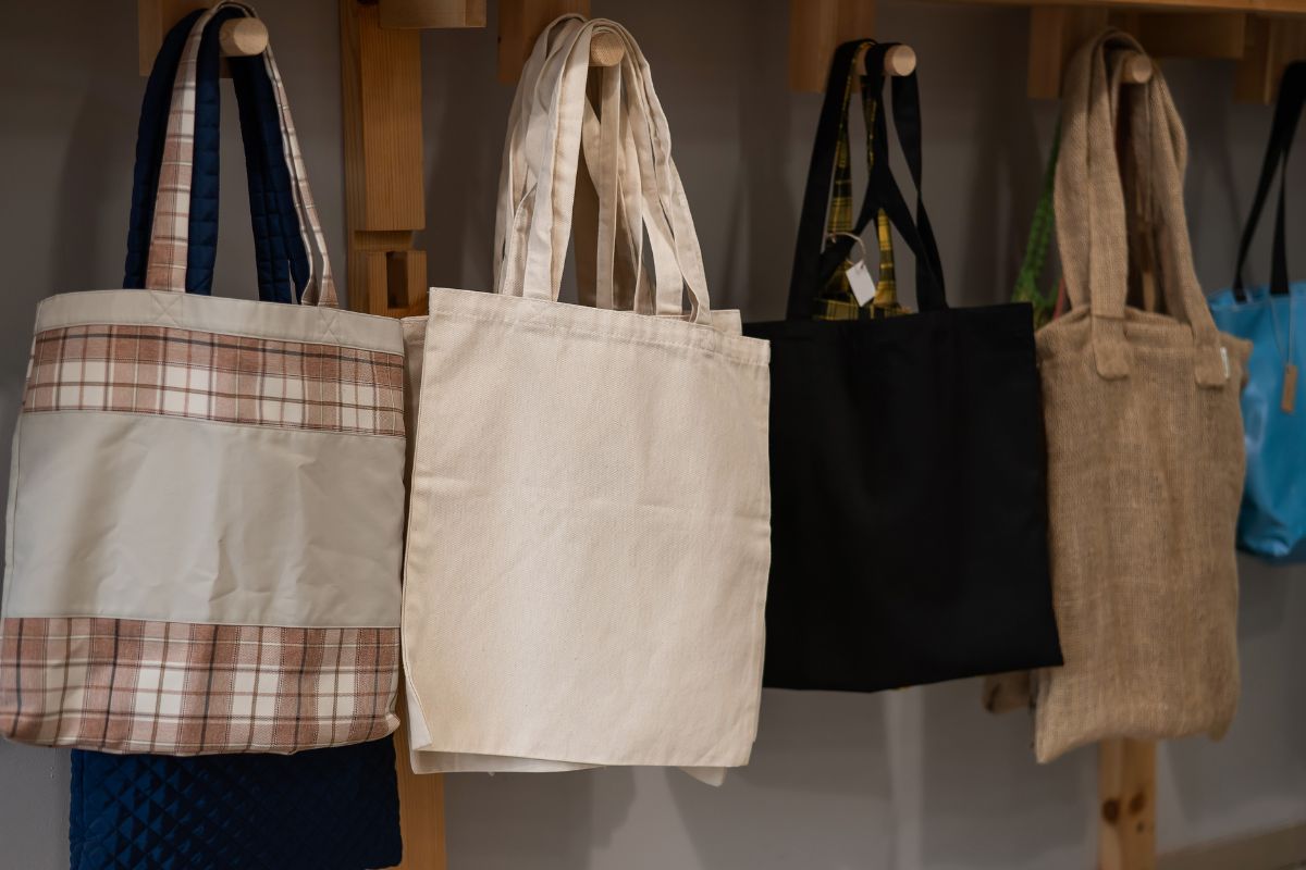 Custom eco friendly tote bags hanged together.