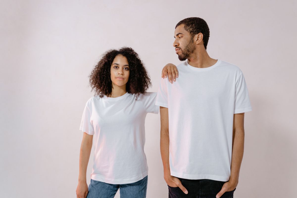 Two friends wearing same t shirt.