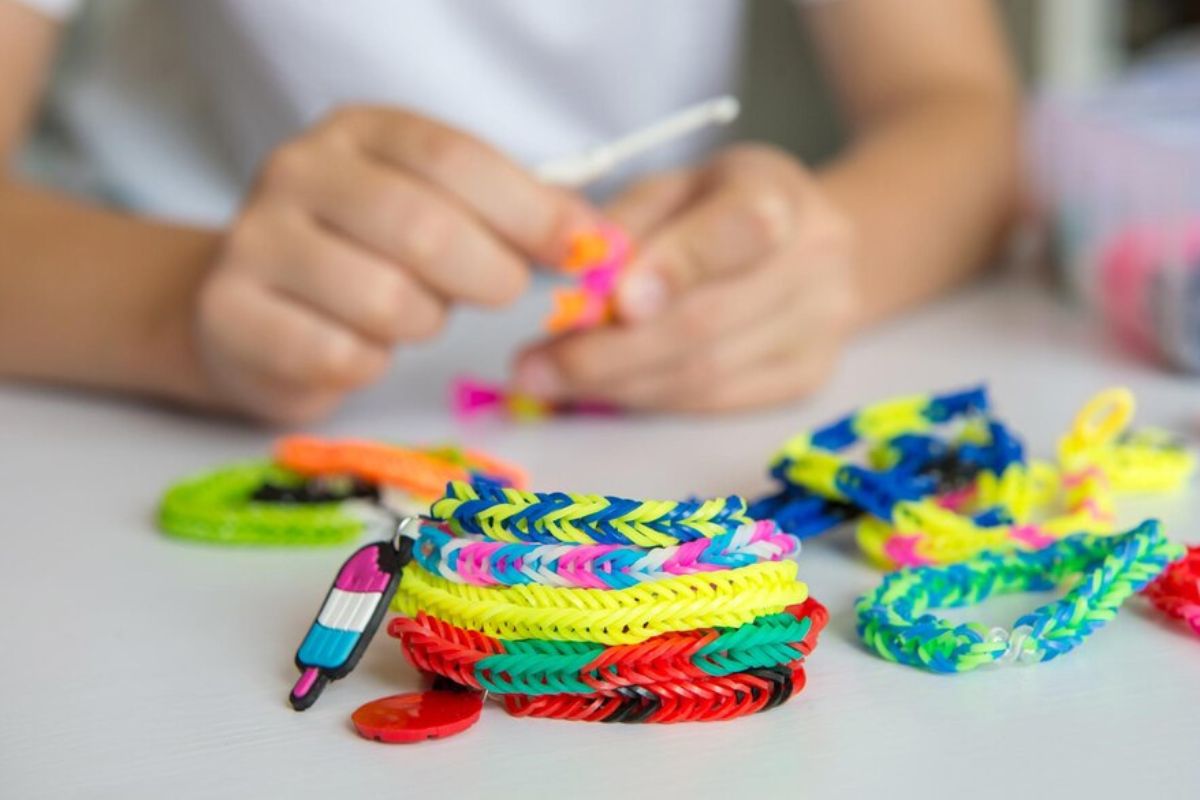 A lady creating custom wristbands by herself