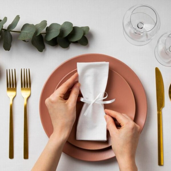 A person folding napkin in different design