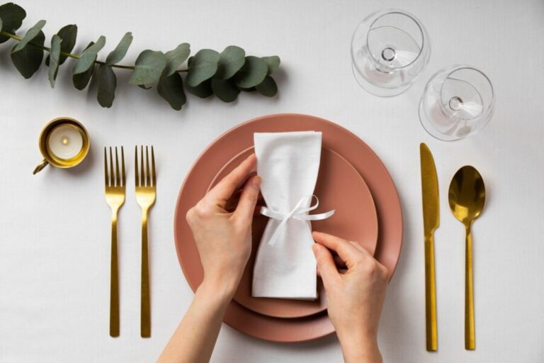 A person folding napkin in different design