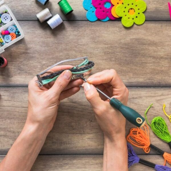 A person making custom wristband and personalizing it.