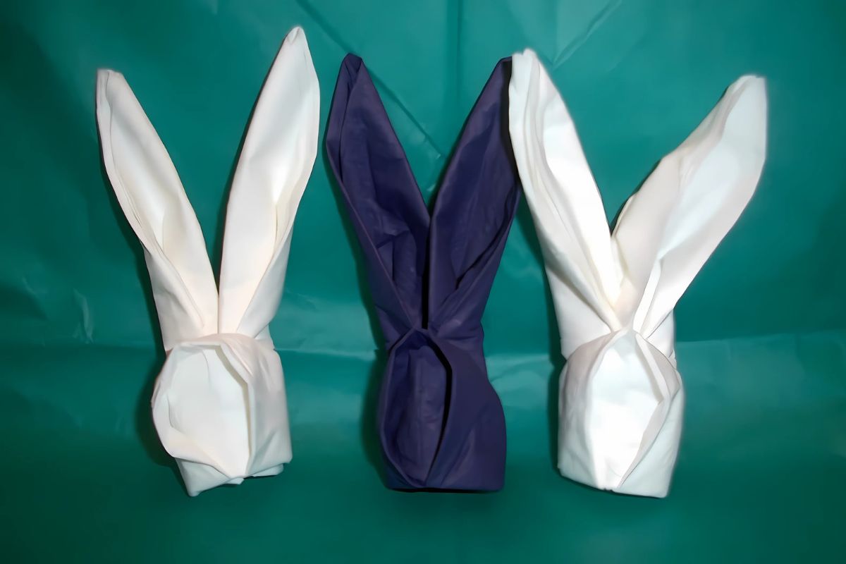 Three bunny fold napkins shown in the image